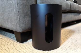 Sonos Sub Mini in front of a sofa.