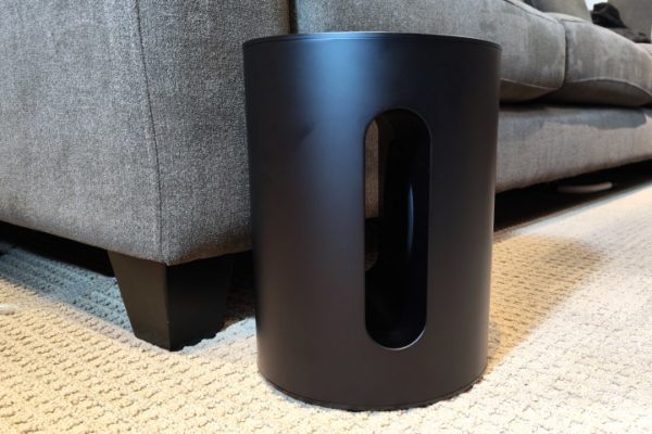 Sonos Sub Mini in front of a sofa.