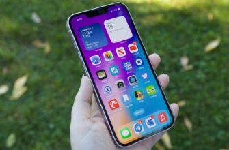 Someone holding an iPhone 14 with the display turned on.