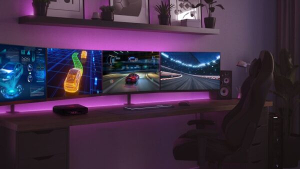 The Asus ROG NUC on a desk surrounded by three monitors. The Asus ROG NUC on a desk surrounded by three monitors.
