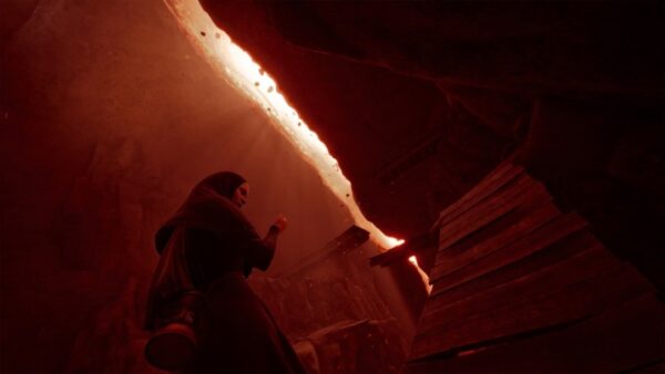 A nun stands in a red room in Indika. A nun stands in a red room in Indika.