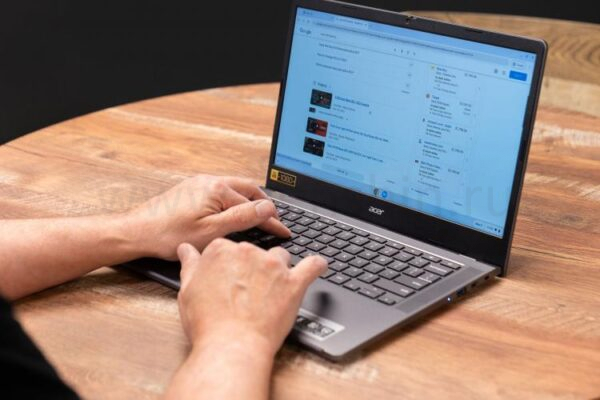 Руки, печатающие на Chromebook Acer на столе.