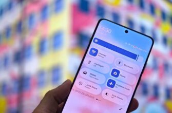 Редизайн меню быстрых настроек Android на телефоне в руке.