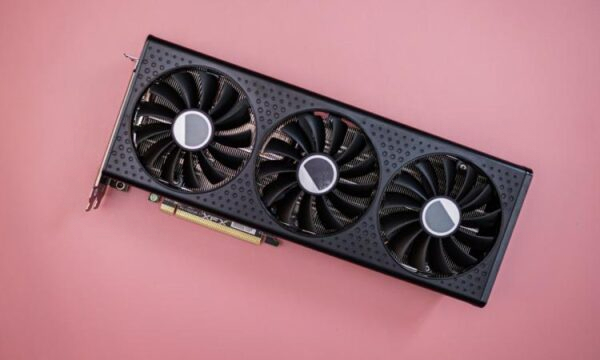 Видеокарта RX 7600 XT на розовом фоне.