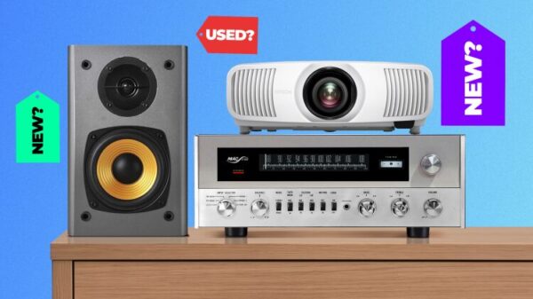 A projector, a receiver, and a speaker on a table, with tags saying 'NEW' and 'USED' around.