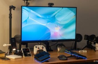 A GIGABYTE M32U 16:9 4K gaming monitor on a desk with a keyboard, controllers, and other accessories.