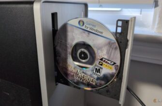 A CD-ROM in an open PC disc drive with a label on the CD reading Games for Windows and the title of the game Company of Heroes Tales of Valor.