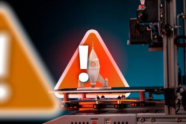 A 3D printer with a printed object and a warning sign.