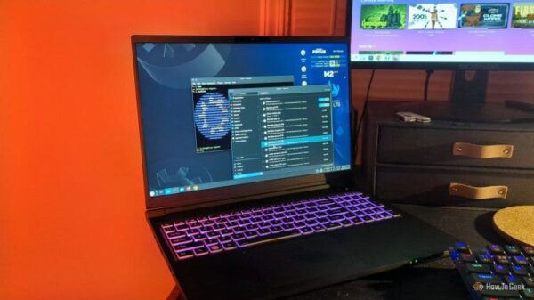 The Kubuntu Focus M2 Gen 6 laptop on a desk with a software updater and Linux terminal open.
