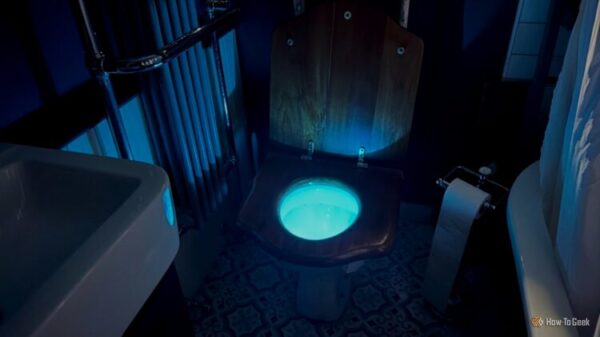 A toilet with the bowl lit up by a motion activated toilet night light.