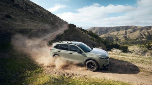 Dynamic front 3/4 shot of a green 2026 Honda CR-V TrailSport