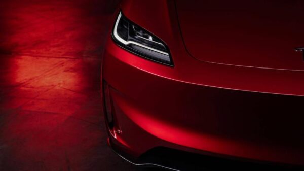 Close-up shot of the front end of a red Tesla Model 3 Performance.