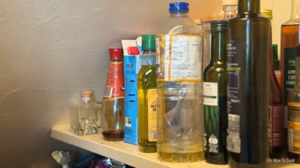The inside of a pantry cupboard with the light on.