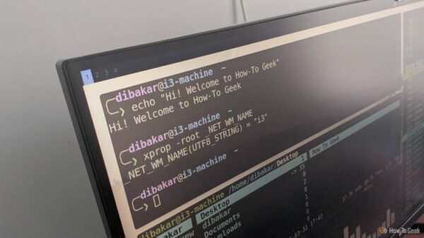 Monitor showing i3 tiled terminal layout with xprop confirming window manager is i3.