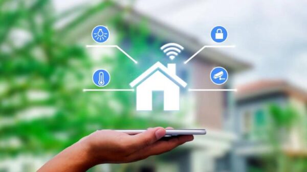 Hands holding smart phone with app smart home on blurred house as backgrounds.