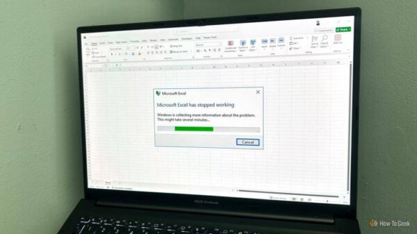 Laptop screen showing the Microsoft Excel has stopped working alert on a blank Excel worksheet.