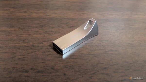 A 256GB Samsung flash drive on a desk.
