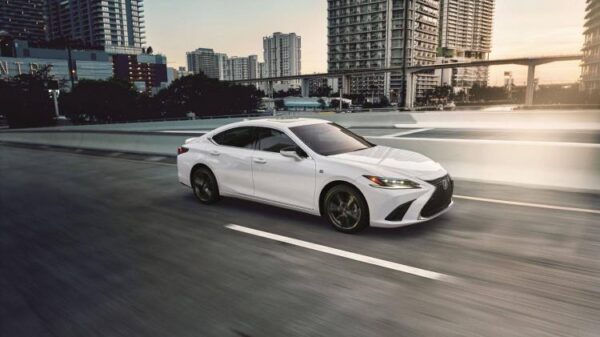 Dynamic side profile shot of a white 2025 Lexus ES 350.