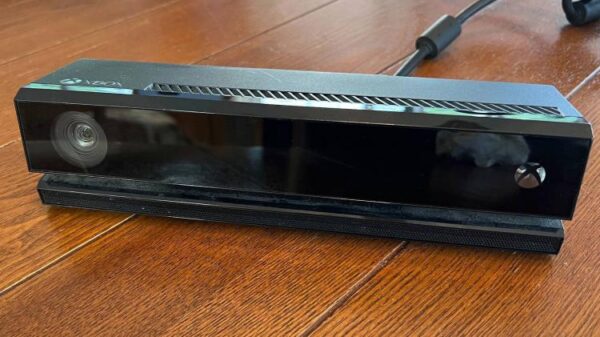 An Xbox One Kinect camera on a dining room table.