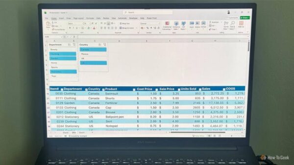 На экране ноутбука ASUS Vivobook таблица Excel с активными срезами и отфильтрованными строками данных.